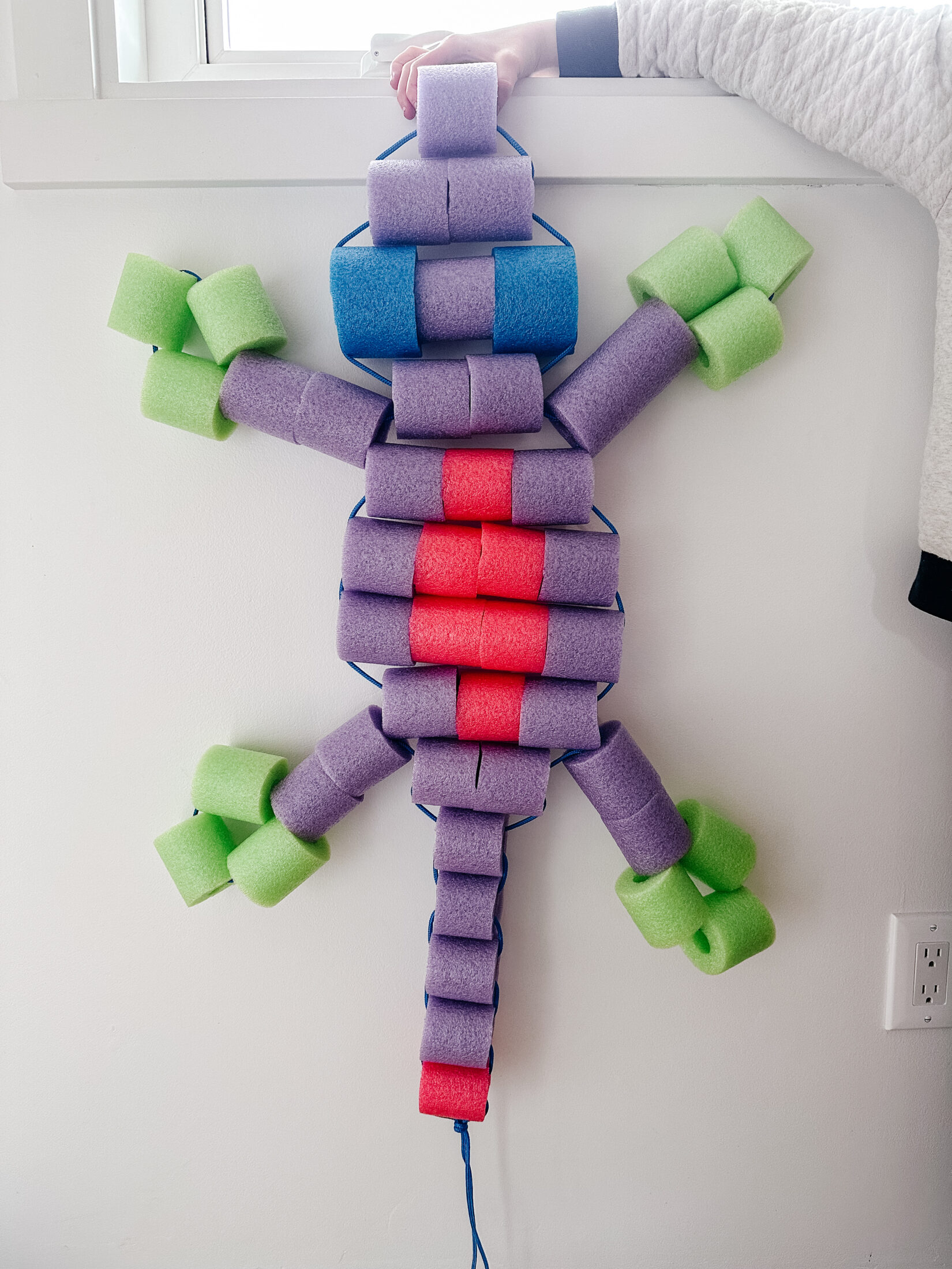 Gecko shaped floatie made from pool noodles.